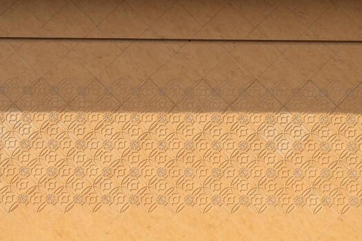 yellow wall that was built in front of the building is a interpretive artwork and is punched into a kind of print and is a beautiful natural marble floor created by the painter. photo