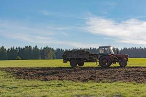 tractor with trailer on a field photo