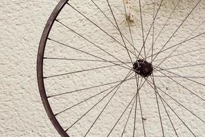 Bicycle wheel hanging outside photo