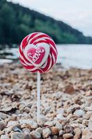 Striped red and white lollipop with Love photo