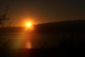 puesta de sol sobre un lago foto