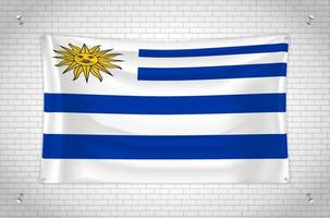 Uruguay flag hanging on brick wall. 3D drawing. Flag attached to the wall. Neatly drawing in groups on separate layers for easy editing. vector