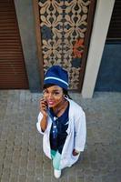 African american doctor female with stethoscope posed outdoor. photo