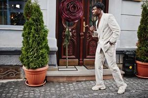 Stylish afro man in beige old school suit. Fashionable young African male in casual jacket on bare torso. photo