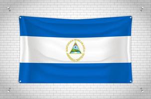 Nicaragua flag hanging on brick wall. 3D drawing. Flag attached to the wall. Neatly drawing in groups on separate layers for easy editing. vector