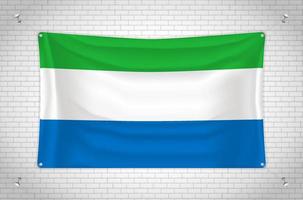 Sierra Leone flag hanging on brick wall. 3D drawing. Flag attached to the wall. Neatly drawing in groups on separate layers for easy editing. vector