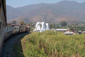 The express train is passing the concrete white bridge. photo