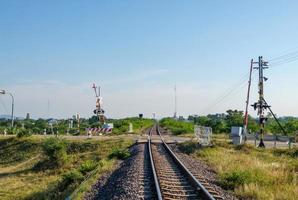 The automatic railroad crossing on the countryside road before the local train station. photo