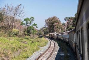 The diesel-electric locomotive is moving pass the signal pole. photo