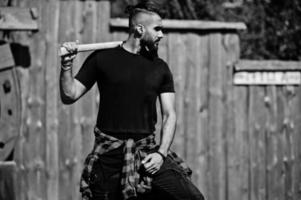 Arab hipster beard man lumberjack hold axe. photo