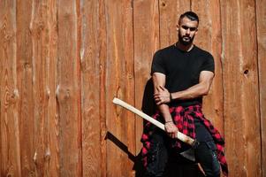 Arab hipster beard man lumberjack hold axe. photo