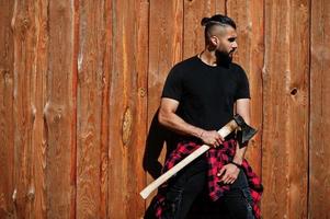 Arab hipster beard man lumberjack hold axe. photo