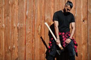 Arab hipster beard man lumberjack hold axe. photo