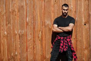 Arab hipster beard man lumberjack against wooden background. photo