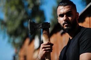 Arab hipster beard man lumberjack hold axe. photo