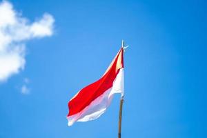 Indonesian flag with sky background photo