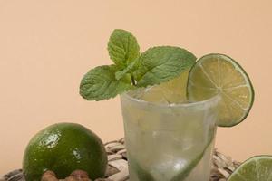 Refreshing cocktail with green lemon and ice. photo