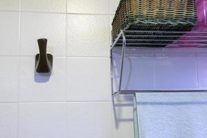 bathroom wall with a towel rack and some accessories. photo