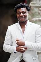 Thoughtful young handsome african american gentleman in formalwear. Black stylish model man in white jacket. photo