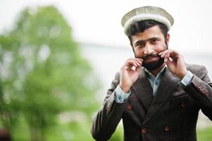 Beard afghanistan man wear pakol hat and jacket. photo