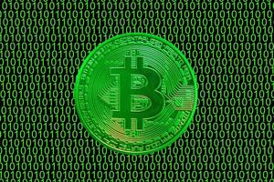 green binary code and a valueable green bitcoin from crypto currency straight photo