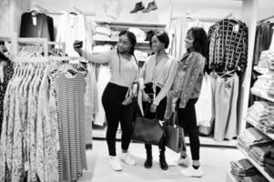 Three african woman at clothes store. Shopping day and time for selfie. photo