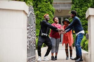 Four african friends having fun outdoors. Two black girls with guys. photo