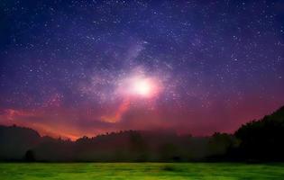 Night landscape with colorful Milky Way and mountains. Starry sky with hills at summer. Beautiful Universe. Space background photo