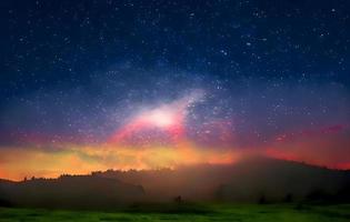 Night landscape with colorful Milky Way and mountains. Starry sky with hills at summer. Beautiful Universe. Space background photo