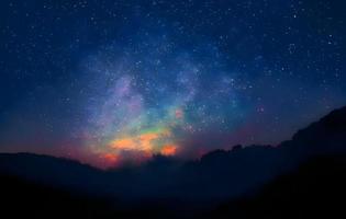 Night landscape with colorful Milky Way and mountains. Starry sky with hills at summer. Beautiful Universe. Space background photo