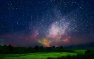 Night landscape with colorful Milky Way and mountains. Starry sky with hills at summer. Beautiful Universe. Space background photo