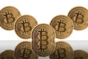 Five bitcoin and shadow on a white background. photo