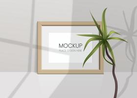 Realistic vector mockup with photo frame and palm tree. Shadow on the wall and empty place for your design. 3d soft light and overlay shadow from plant leaf and window. Horizontal poster or painting.