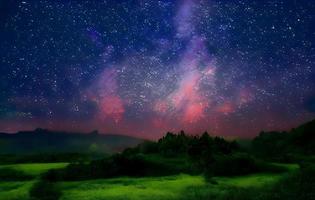 Night landscape with colorful Milky Way and mountains. Starry sky with hills at summer. Beautiful Universe. Space background photo