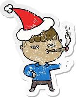 distressed sticker cartoon of a man smoking wearing santa hat vector