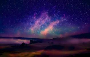 Night landscape with colorful Milky Way and mountains. Starry sky with hills at summer. Beautiful Universe. Space background photo