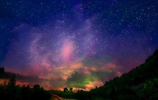 Milky Way and pink light at mountains. Night colorful landscape. Starry sky with hills at summer. Beautiful Universe. Space background with galaxy. Travel background photo