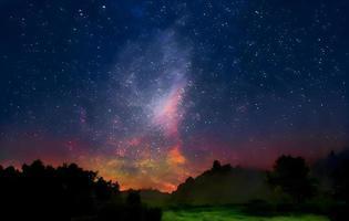 Night landscape with colorful Milky Way and mountains. Starry sky with hills at summer. Beautiful Universe. Space background photo