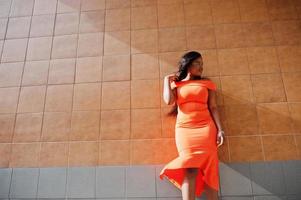 African american woman model xxl in orange dress. photo