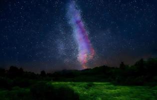 Night landscape with colorful Milky Way and mountains. Starry sky with hills at summer. Beautiful Universe. Space background photo