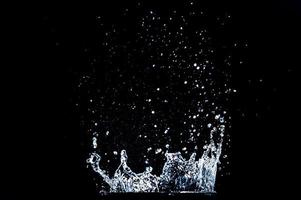 Abstract background of Water splashing on a black background. idea for freshness photo