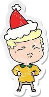 distressed sticker cartoon of a annoyed man wearing santa hat vector