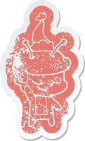 friendly cartoon distressed sticker of a spaceman wearing santa hat vector