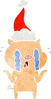 crying pig retro cartoon of a wearing santa hat vector