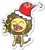 distressed sticker cartoon of a roaring lion wearing santa hat vector