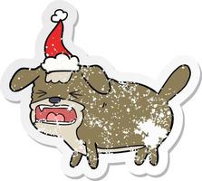 distressed sticker cartoon of a dog barking wearing santa hat vector