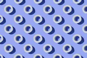 Seamless Pattern made of Toilet paper rolls isolated on blue background. The concept of hygiene. Pandemic panic concept. photo