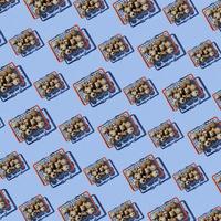 Seamless pattern of shopping baskets big and small with quail eggs on blue background. Top view. Website background. photo