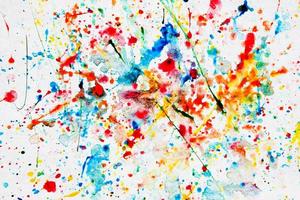 Colorful watercolor splash on white paper photo