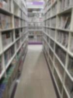 Blurred corridor of Books arranged on shelves, bookshelf in the shop or in the library, backgroud photo